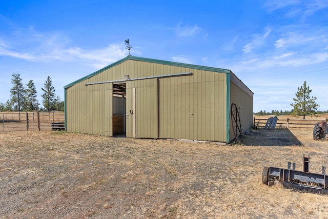 view of outdoor structure with a rural view