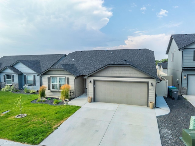 view of front of property with a front yard and a garage