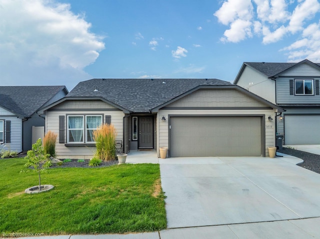 view of front of house with a front yard and a garage