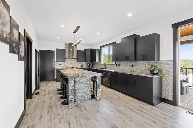 kitchen with sink, a center island, pendant lighting, a kitchen bar, and decorative backsplash