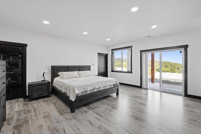 bedroom featuring light hardwood / wood-style floors and access to exterior