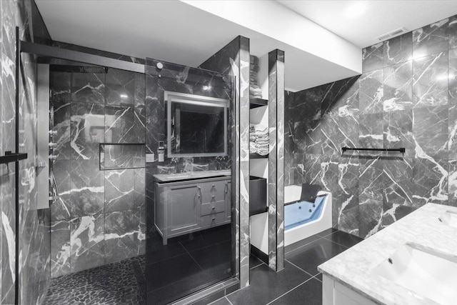 bathroom featuring an enclosed shower, vanity, and tile walls