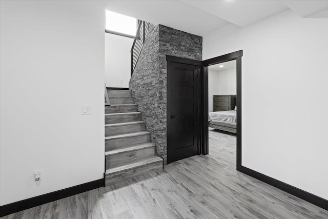 staircase featuring wood-type flooring