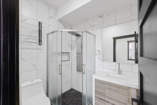 bathroom featuring an enclosed shower, vanity, toilet, and tile walls