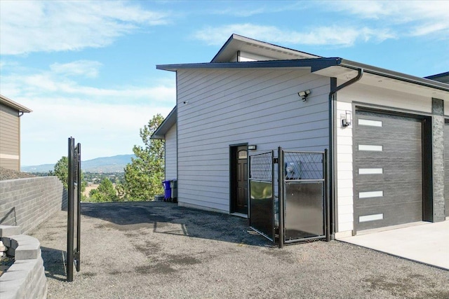 view of side of home featuring a mountain view and a garage