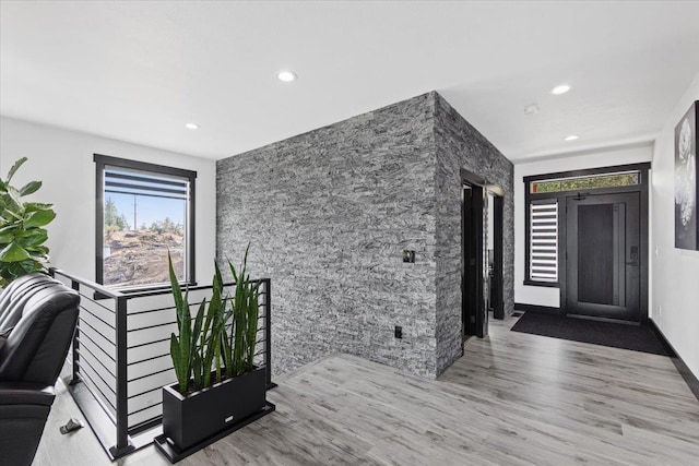 entryway with hardwood / wood-style floors