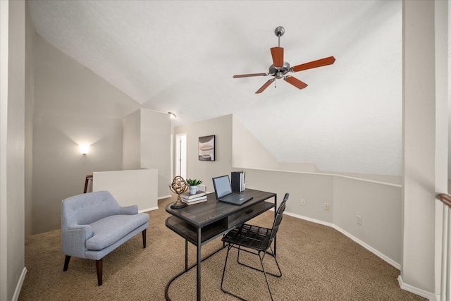 home office with carpet flooring, ceiling fan, and vaulted ceiling