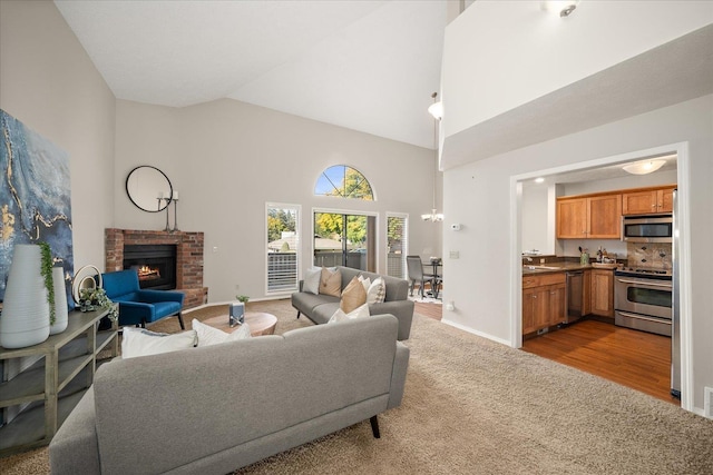 living room featuring a fireplace, light carpet, and high vaulted ceiling