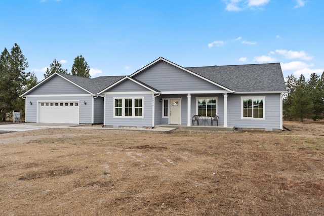 ranch-style house with covered porch and a garage