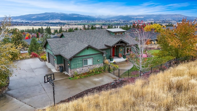 craftsman-style house with a mountain view, a garage, and central AC unit