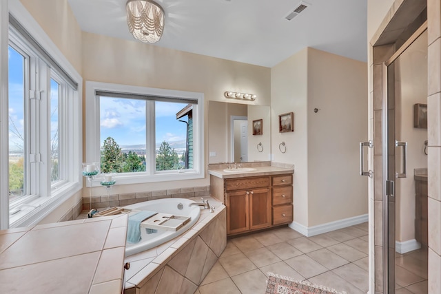 bathroom featuring tile patterned floors, a chandelier, vanity, and a healthy amount of sunlight