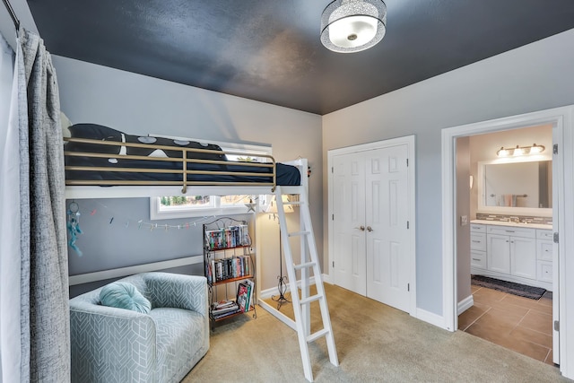 carpeted bedroom featuring ensuite bath