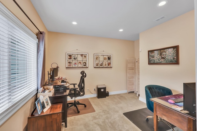 office with plenty of natural light and light carpet