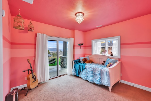 carpeted bedroom featuring access to exterior