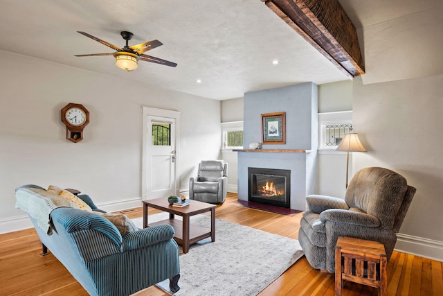 living room with ceiling fan and light hardwood / wood-style floors