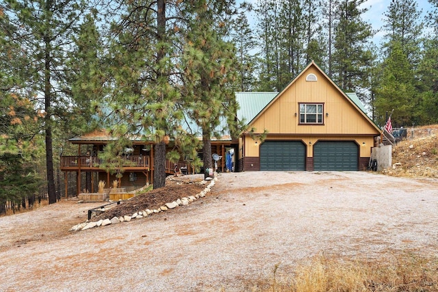 view of front of home featuring a wooden deck and a garage