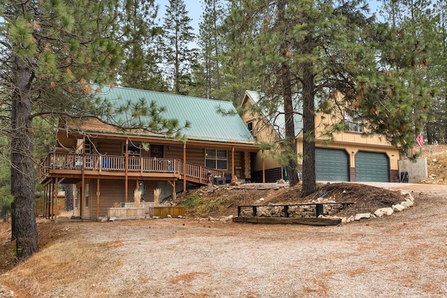 cabin featuring a deck and a garage