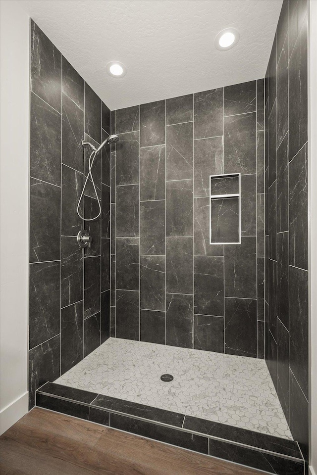 4217 W Tolliver Ct, Spokane, WA 99208 - bathroom with a tile shower, recessed lighting, and wood finished floors
