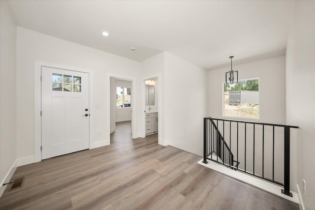 4217 W Tolliver Ct, Spokane, WA 99208 - foyer entrance featuring light wood-type flooring, a chandelier, and recessed lighting