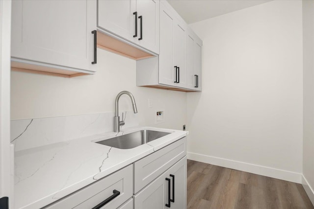 4217 W Tolliver Ct, Spokane, WA 99208 - kitchen featuring light stone countertops, wood finished floors, and white cabinets