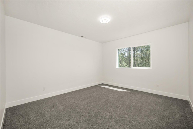 4217 W Tolliver Ct, Spokane, WA 99208 - spare room with baseboards and dark carpet