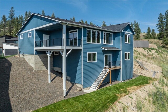 4217 W Tolliver Ct, Spokane, WA 99208 - back of property featuring a balcony and stairs