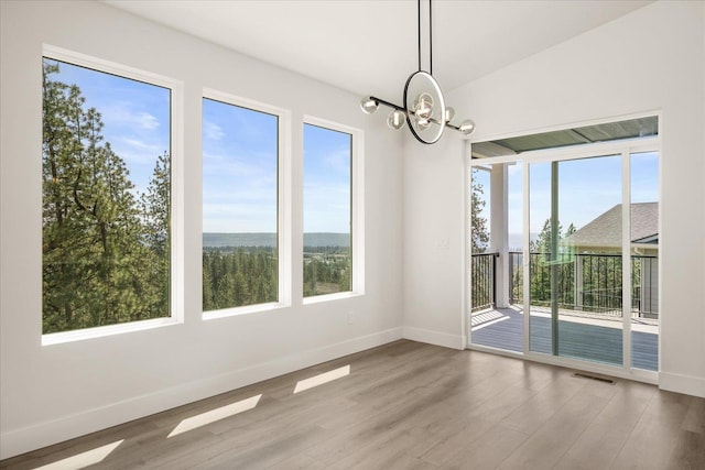 4217 W Tolliver Ct, Spokane, WA 99208 - unfurnished room featuring a chandelier, wood finished floors, and plenty of natural light