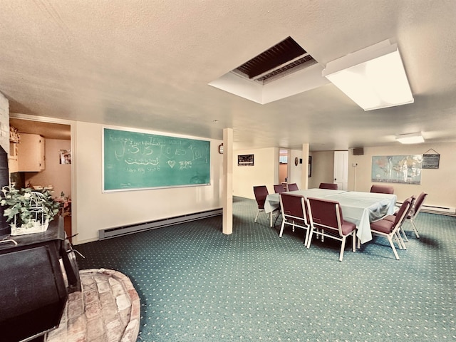 dining area featuring carpet, a textured ceiling, and baseboard heating