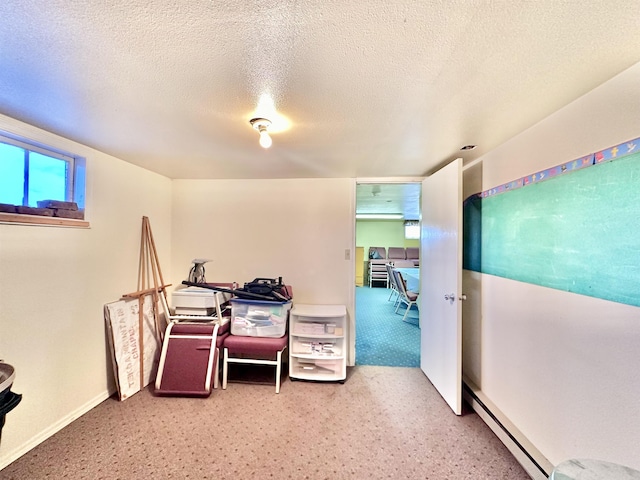 interior space with carpet, a textured ceiling, and a baseboard heating unit