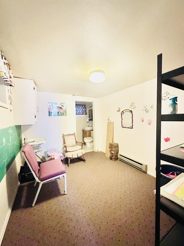 living area with carpet floors and a baseboard heating unit