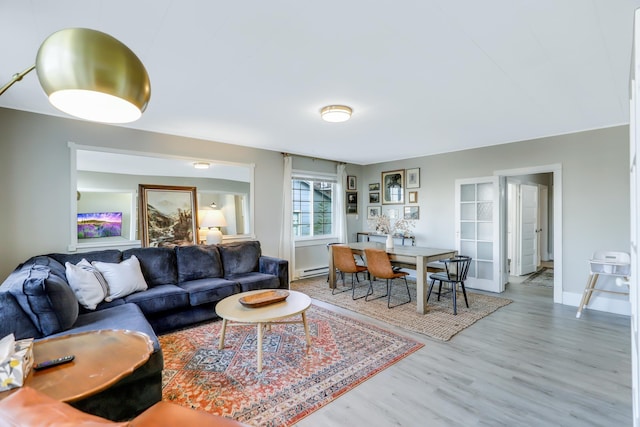 living room featuring hardwood / wood-style flooring and a baseboard heating unit