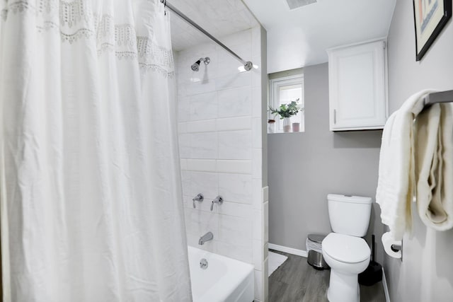 bathroom with shower / bath combo, hardwood / wood-style flooring, and toilet