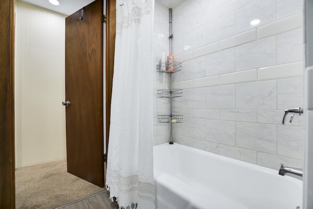 bathroom featuring hardwood / wood-style floors and shower / bath combo