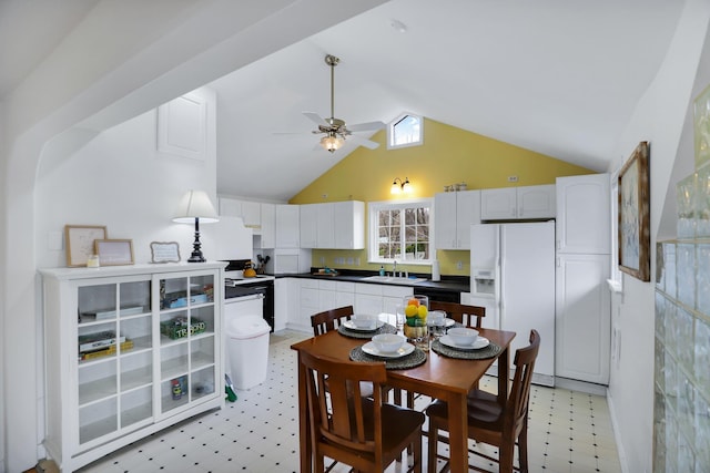 dining room with high vaulted ceiling, ceiling fan, and sink