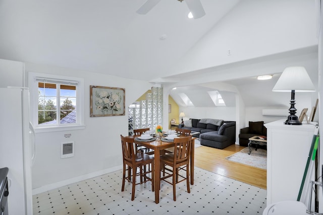 dining space featuring heating unit, ceiling fan, and vaulted ceiling