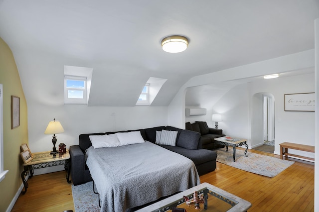 bedroom featuring hardwood / wood-style floors and lofted ceiling