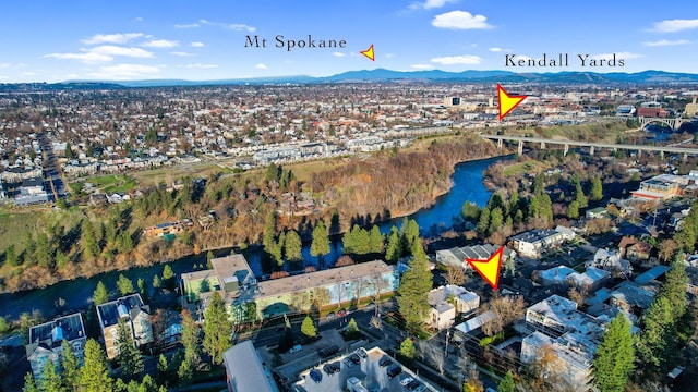 drone / aerial view featuring a water and mountain view