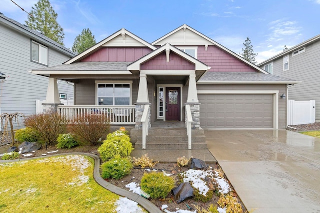 craftsman-style house featuring a porch and a garage