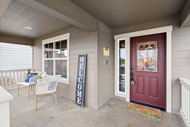 view of exterior entry featuring a porch