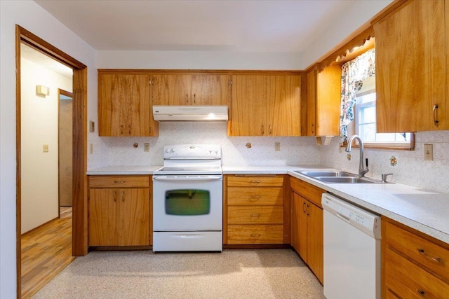 kitchen featuring tasteful backsplash, sink, and white appliances