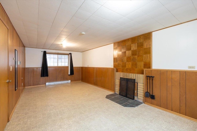 basement with a brick fireplace and a baseboard heating unit