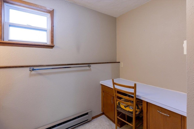 interior space featuring built in desk and a baseboard radiator