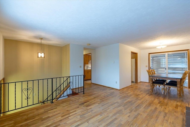 unfurnished room featuring hardwood / wood-style floors and a textured ceiling