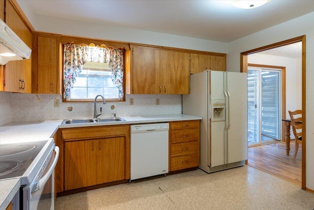 kitchen featuring ventilation hood, white appliances, tasteful backsplash, and sink