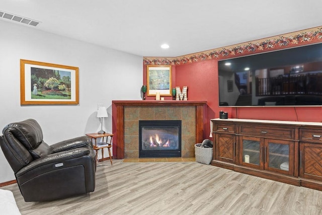 living room featuring a fireplace and light hardwood / wood-style flooring