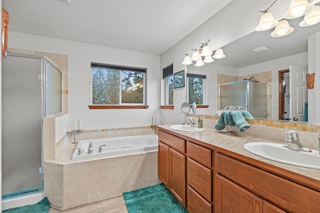 bathroom featuring vanity, plus walk in shower, and an inviting chandelier