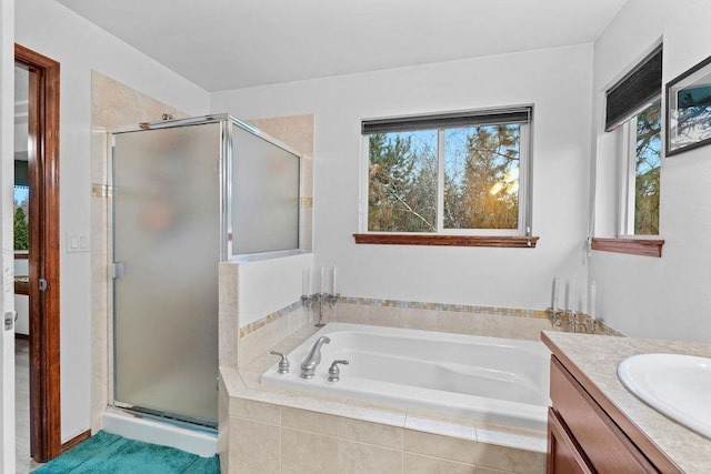 bathroom with shower with separate bathtub and vanity