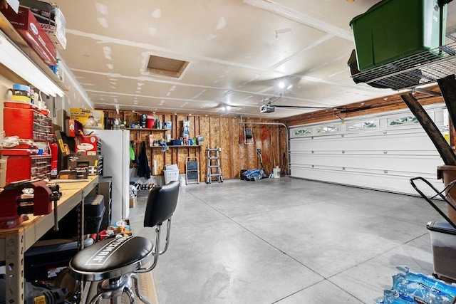 garage featuring a workshop area and a garage door opener