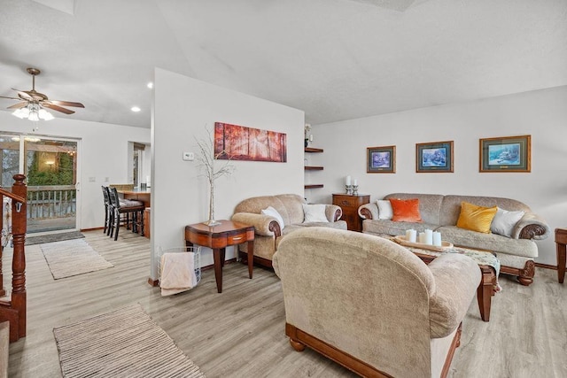 living room featuring ceiling fan and light hardwood / wood-style floors