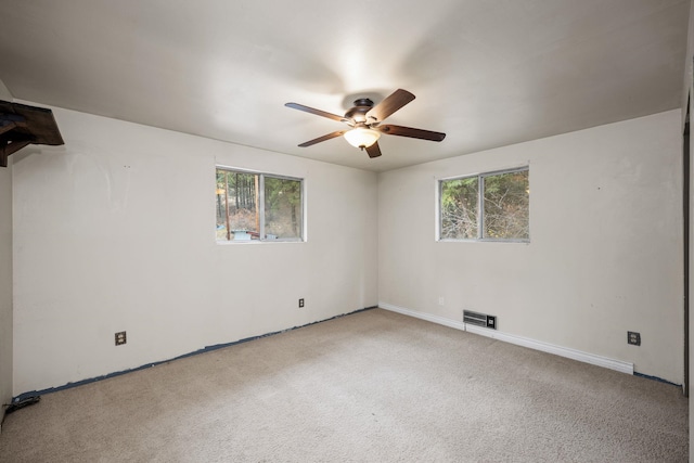 carpeted empty room featuring ceiling fan